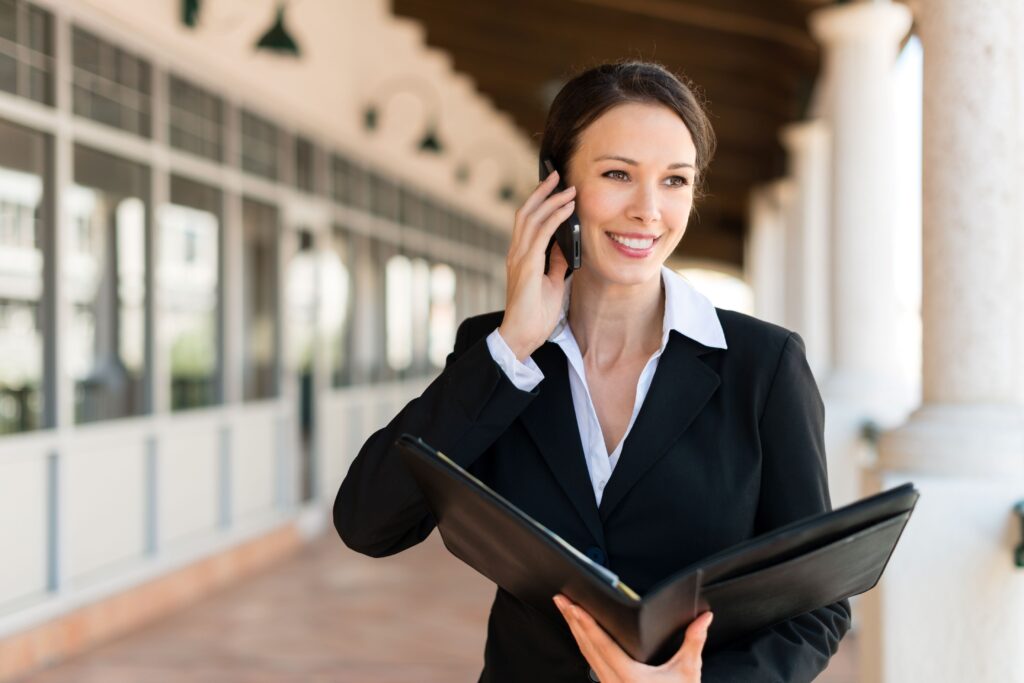 A real estate professional standing in front of her office.