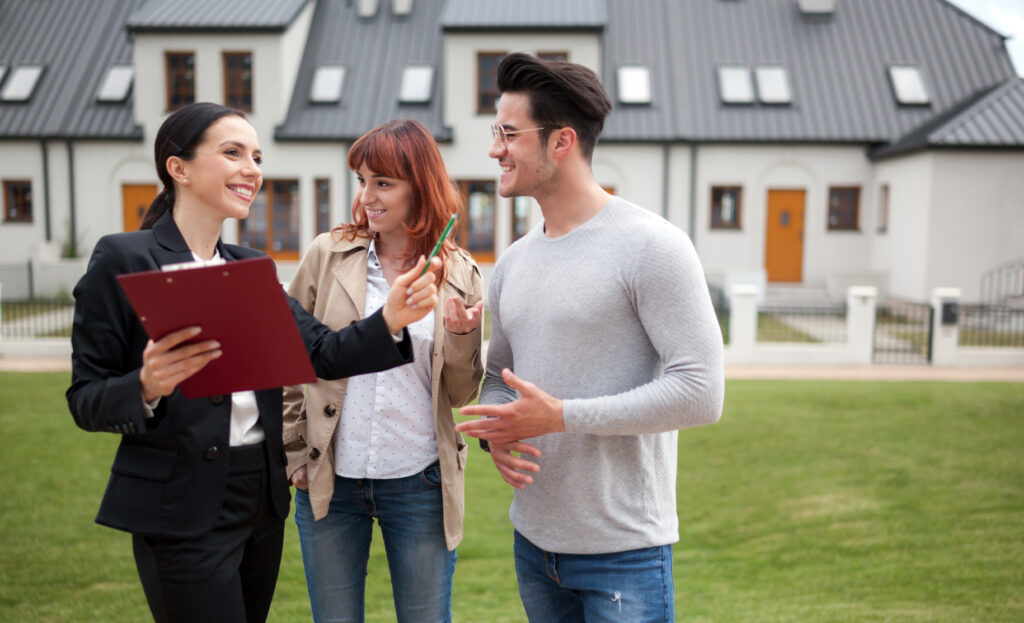 A buying agent showing referral clients around a new condo property.