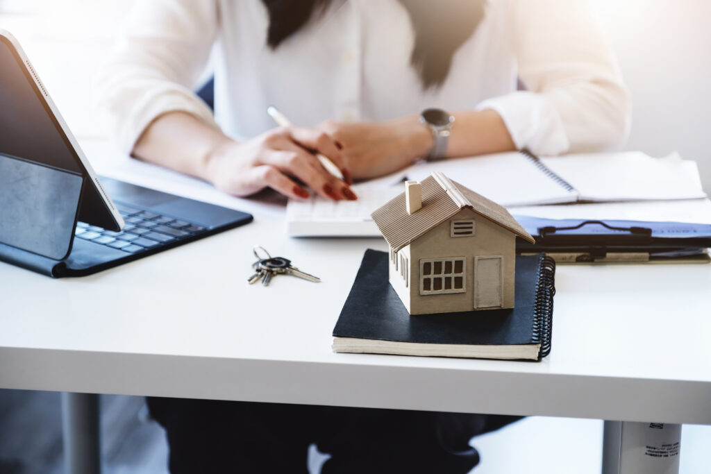 An image of a real estate agent scheduling using a CRM and a date book.