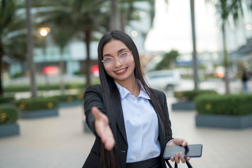 An image of a seasoned real estate agent reaching out a hand to offer real estate agent tips for beginners.